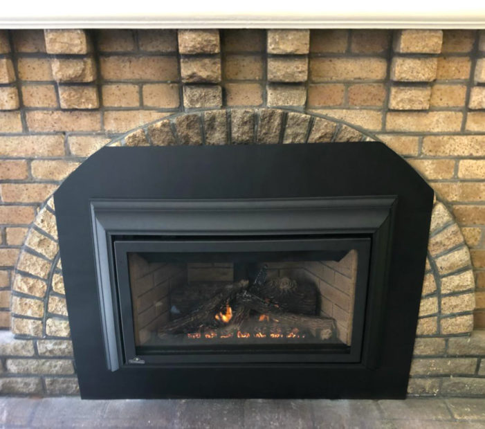 Propane Fireplace in a brick wall in the living room in Mountain View